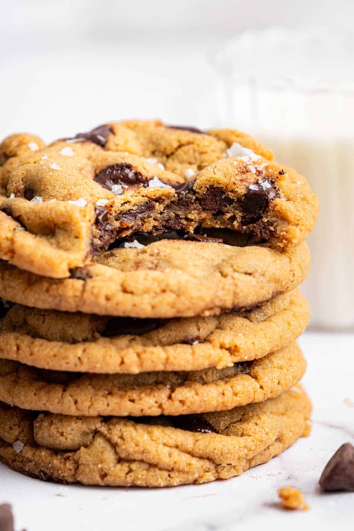 Stack of cookies with one bite missing from top cookie.