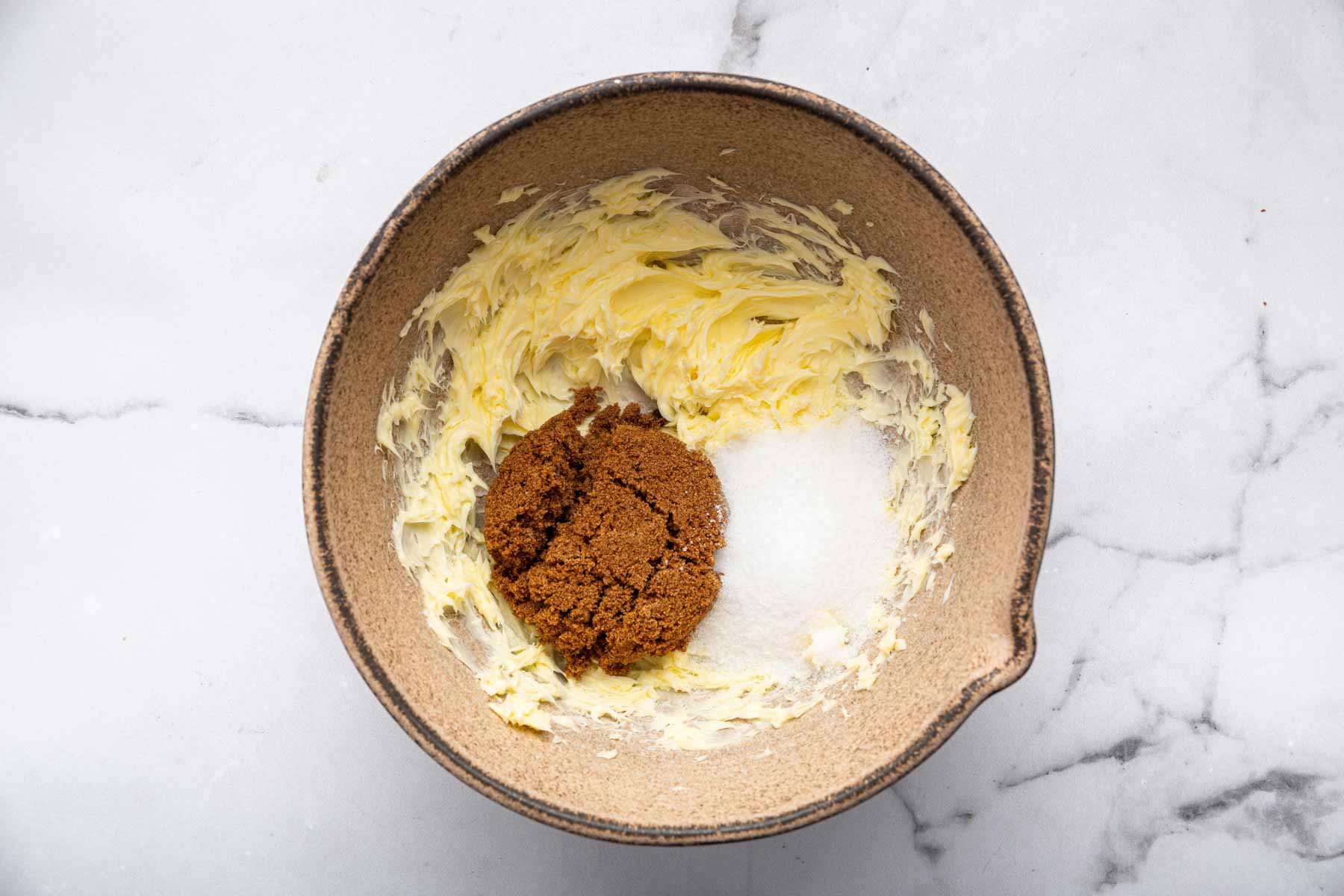 Mixing bowl with two types of sugar in it.