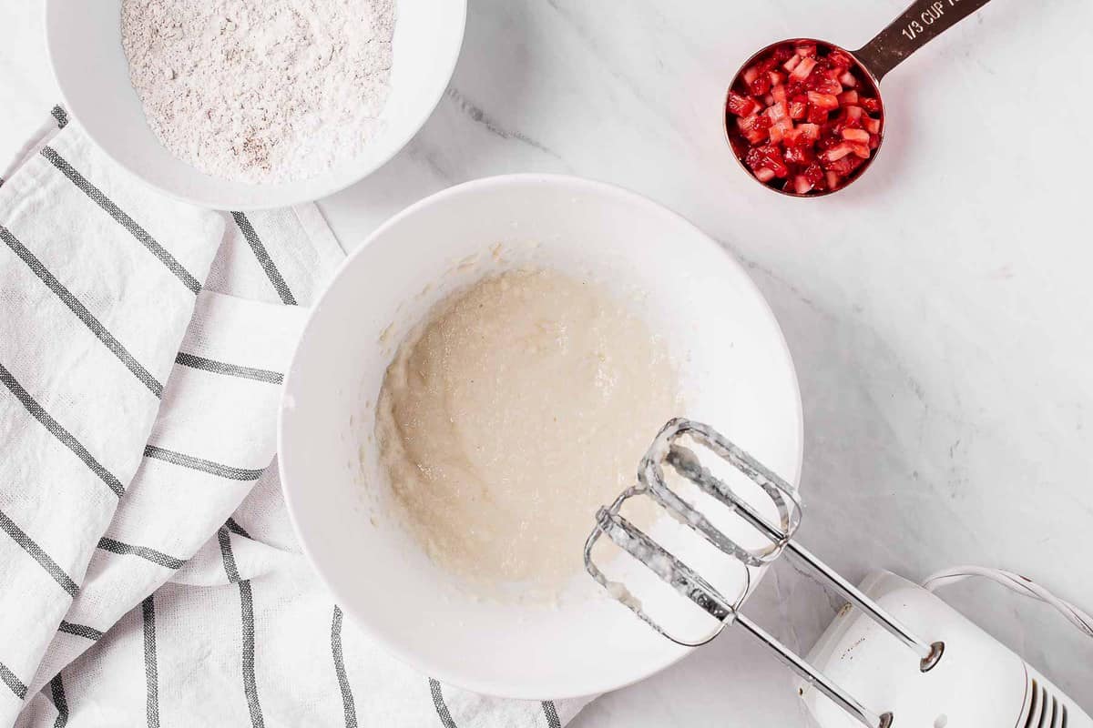 White batter for strawberry muffins in a white bowl.