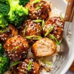Bowl of teriyaki chicken meatballs over rice with broccoli on the side.