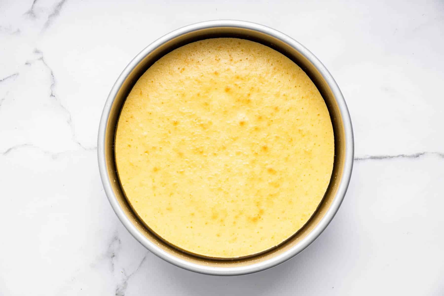 Round yellow cake in pan.
